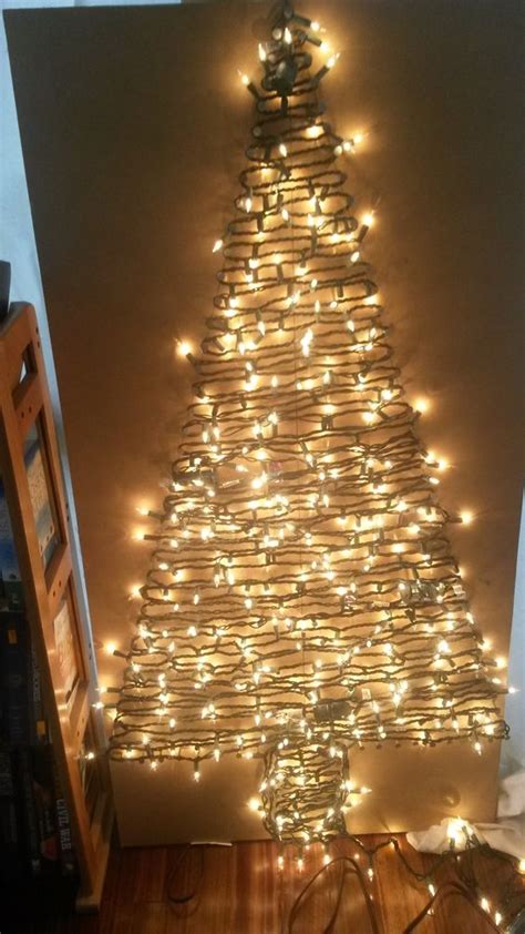 A Christmas Tree Made Out Of Books And Lights