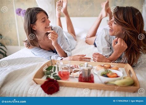Lesbians Sitting Legs Crossed Breakfast In Bed Talking Smiling Lesbian Couple Romantic