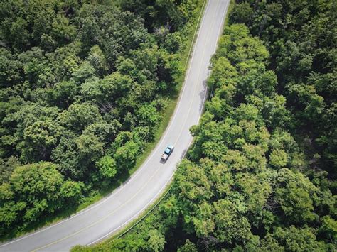 Premium Photo | Curve road top aerial top view rural road in the forest ...