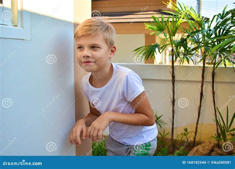 Hide And Seek Boy Sneaks Along The Wall The Kid Sneaks Around The