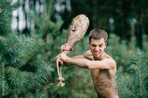 Odd Primitive Naked Man With Huge Wooden Stick Hunting In Forest Adult