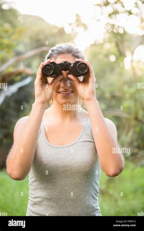 Smiling Pretty Brunette Looking Through Binoculars Stock Photo Alamy