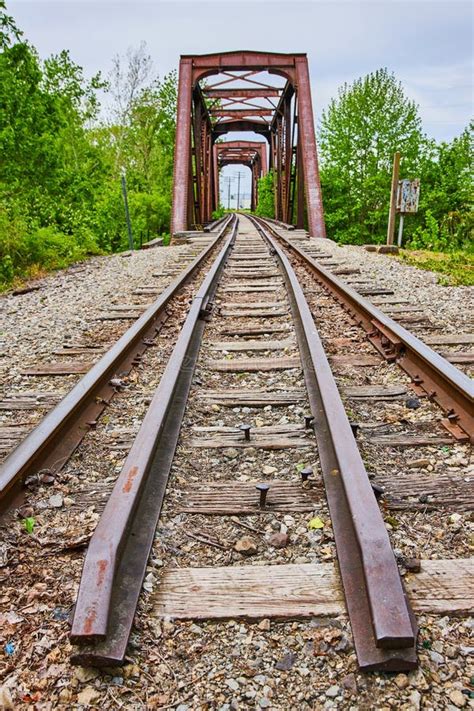 Rusty Truss Iron Railroad Bridge With Train Tracks Over Kokosing River