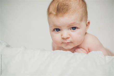 Close Up Of Cute Naked Baby Girl With Blue Eyes By Stocksy