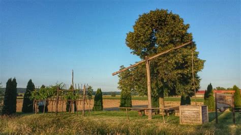 An Old Wooden Structure Sitting In The Middle Of A Field Next To A