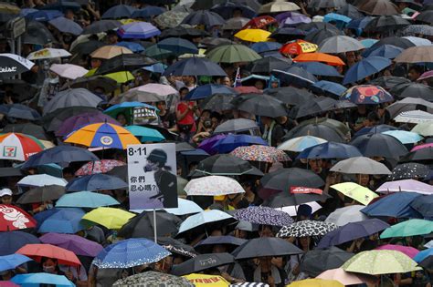 Hong Kong Protesters Defy Threats From Beijing Police And Heavy Rain