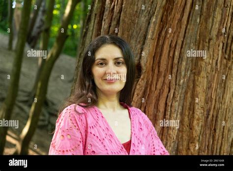 Portrait Of A Year Old Brunette Woman Looking At The Camera Smiling In Nature Stock Photo Alamy