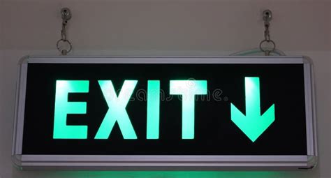 Closeup of a Green EXIT Sign with an Arrow Pointing Down Stock Photo ...