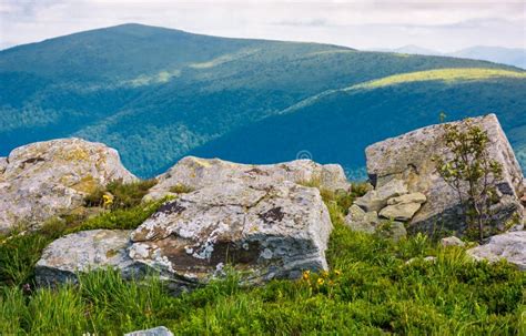 Giant Boulder on a Cliff Over the Grassy Hillside Stock Image - Image ...