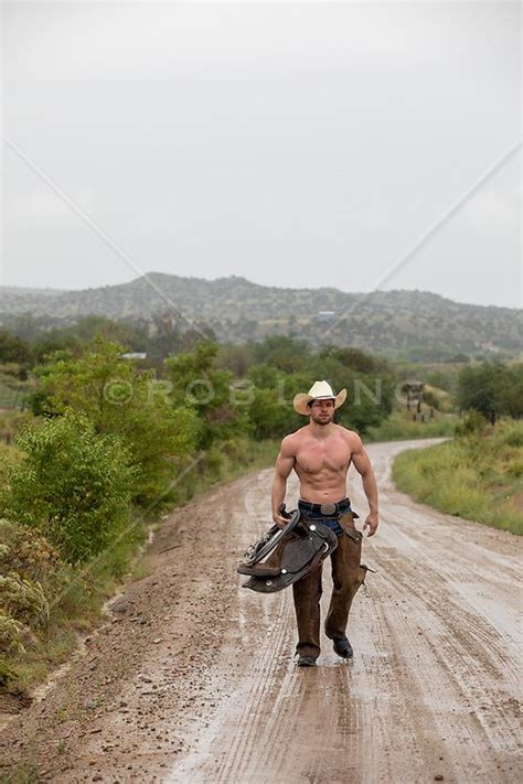 Shirtless Cowboy In The Rain Walking On A Muddy Dirt Road Shirtless