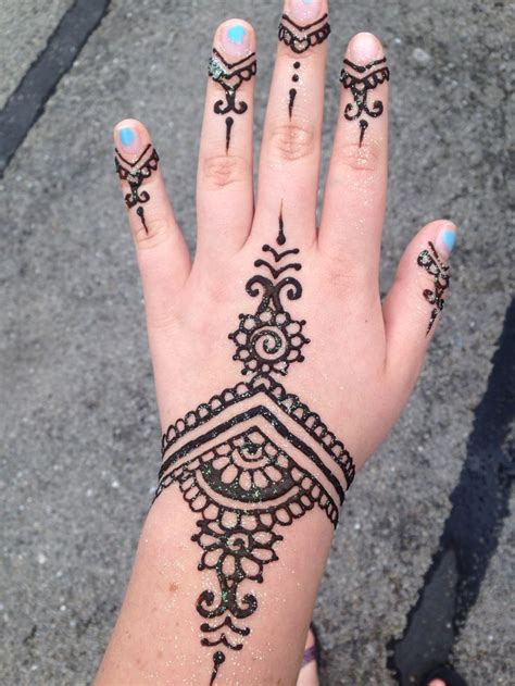 A Woman S Hand With Henna Tattoos On It