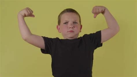 Cute Young Kid Flexing His Muscles in Fr... | Stock Video | Pond5