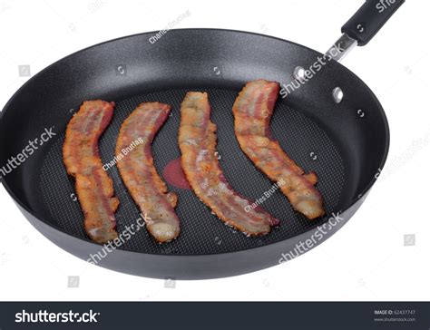 Cooking Bacon In A Frying Pan Isolated On White Stock Photo 62437747