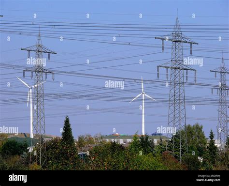 High Voltage Pylons And Wind Turbines For Power Generation Near