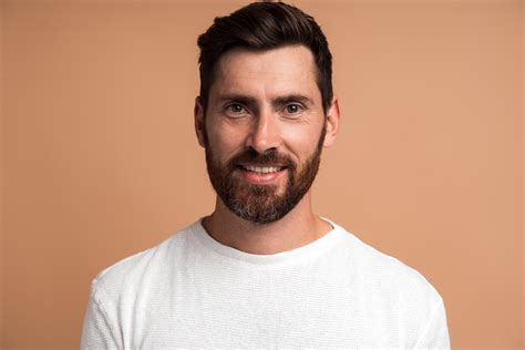 Portrait Of Cheerful Handsome Man In White Shirt Looking At Camera