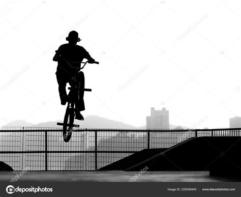 Man Exercising Bmx Acrobatic Figure In Silhouette Stock Photo