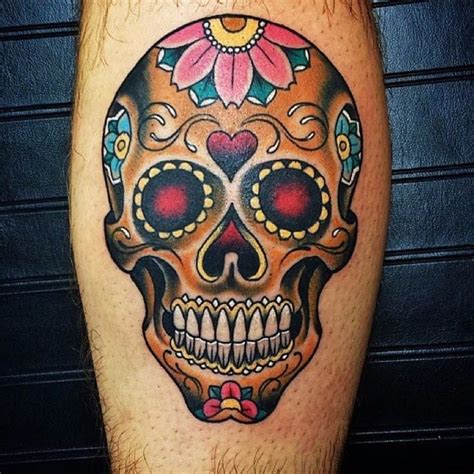 A Man S Leg With A Colorful Skull And Flower Tattoo On The Side Of His Leg