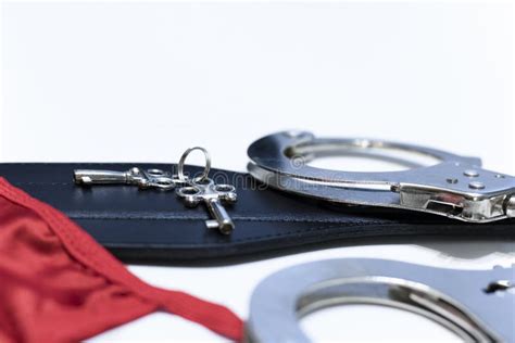 Sex Toys Leather Paddle And Handcuffs With Keys And Women S Red Panties On A White Background