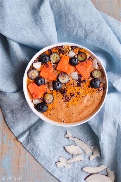 A White Bowl Filled With Carrots Cucumbers And Other Vegetables On Top