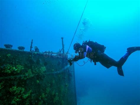 Scuba Diver Exploring A Large Shipwreck Stock Image Image Of Explorer