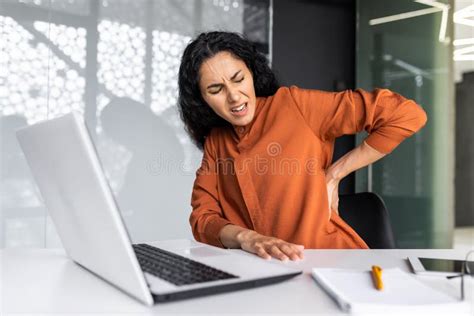 Sick And Overtired Latin American Business Woman Working Inside Office