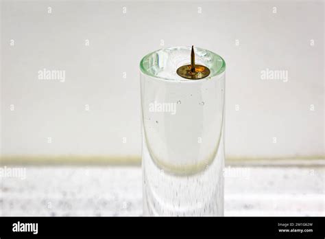 A metal pin floats on water due to the surface tension caused by the ...