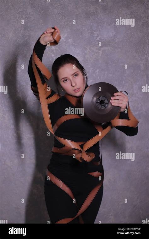 Brunette Girl Wrapped In A Film Reel Stock Photo Alamy