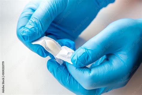 A Gloved Doctor Opens Suppositories For Anal Or Vaginal Use Medical