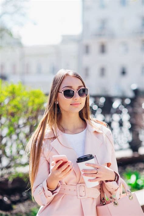 Upper Class Woman Fashionable Woman Texting Outdoors Fashion Woman In A Sunglasses And Pink