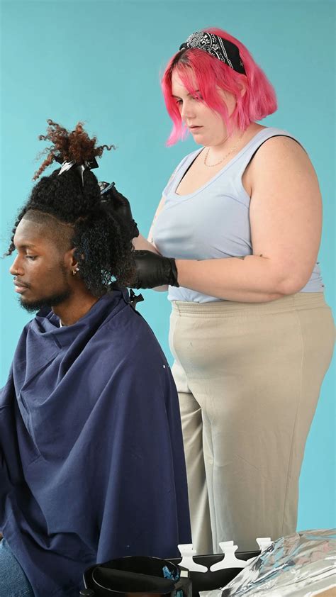 female hair stylist combing  mans hair  stock video