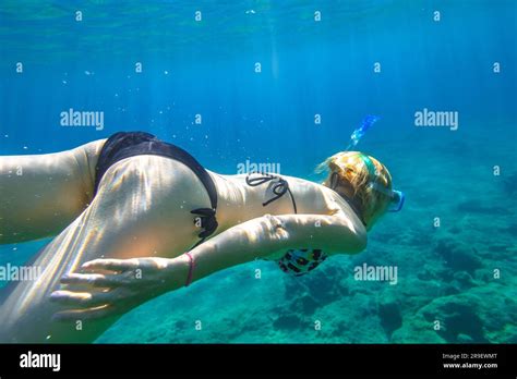 Female Apnea Bikini Swims In Crystal Sea Underwater Background Of A