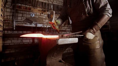 Forging a Knife Out of the Hot Metal - Holding the Knife between the ...