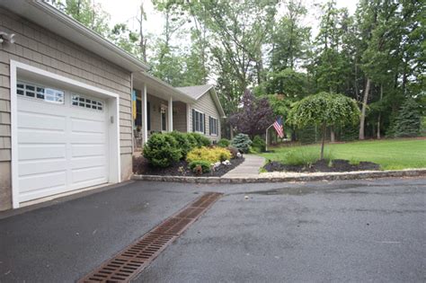 Driveway Drainage system installed with grating and proper slope of asphalt | Outdoor ...