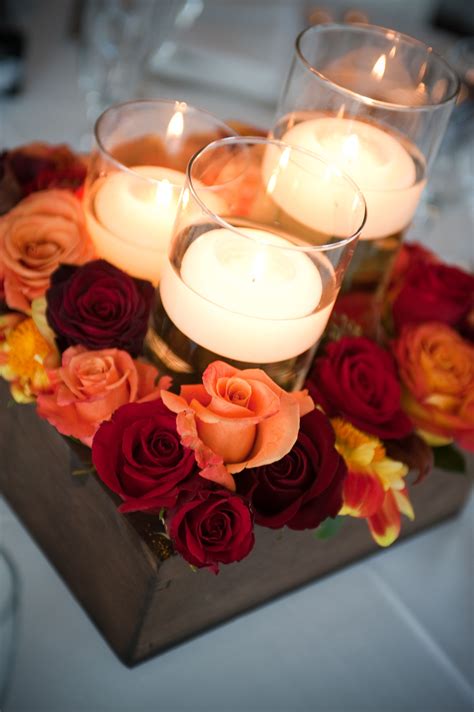 there are many candles that are in the center of this table with ...