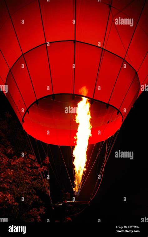 Hot air balloon glowing in the night Stock Photo - Alamy