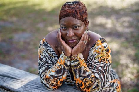 Portrait Of A Beautiful Plus Sized Model In The Park Stock Photo