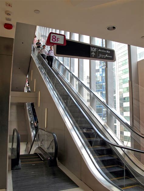 An Escalator In A Building With People On It