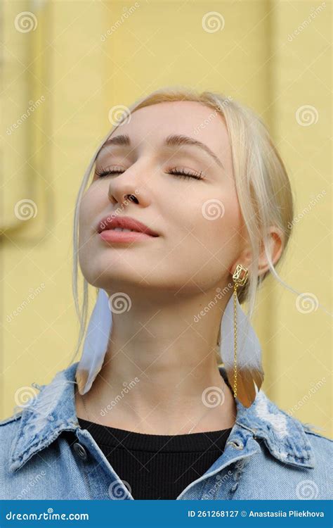 Close Up Portrait Of Pretty Blonde Girl In Hippie Feather Earrings