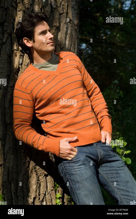 Man Leaning Against A Tree Stock Photo Alamy