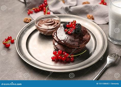 Delicious Chocolate Pancakes Decorated With Berries And Sweet Syrup On