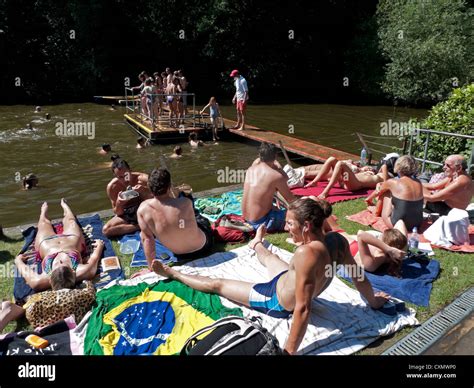 People Sunbathing And Mixed Swimming At AHampstead Heath Pond On A