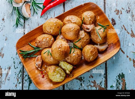 Baked Potatoes Whole In Their Skins With Rosemary And Garlic Stock