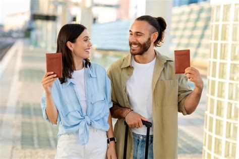 Premium Photo Glad Millennial Caucasian Man And Lady With Suitcase