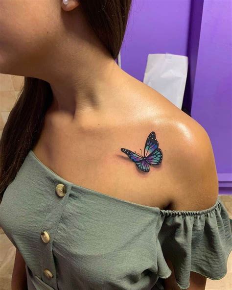 A Woman With A Butterfly Tattoo On Her Shoulder