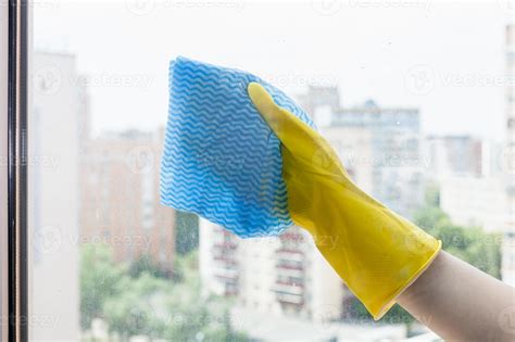 hand wipes glass of home window by blue rag 11372577 Stock Photo at Vecteezy