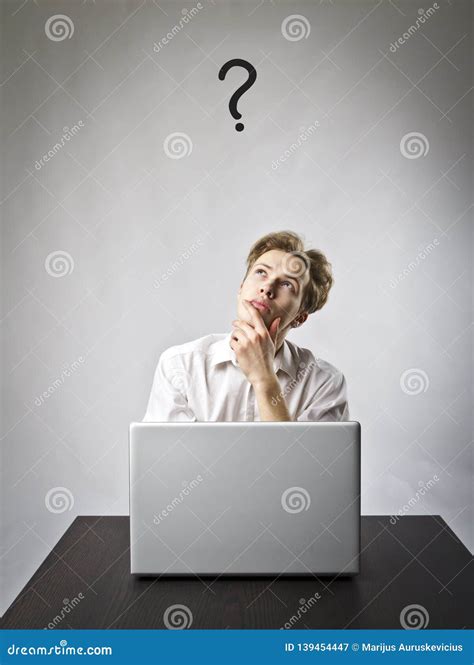 Young Man With Laptop Question And Ignorance Concept Stock Image