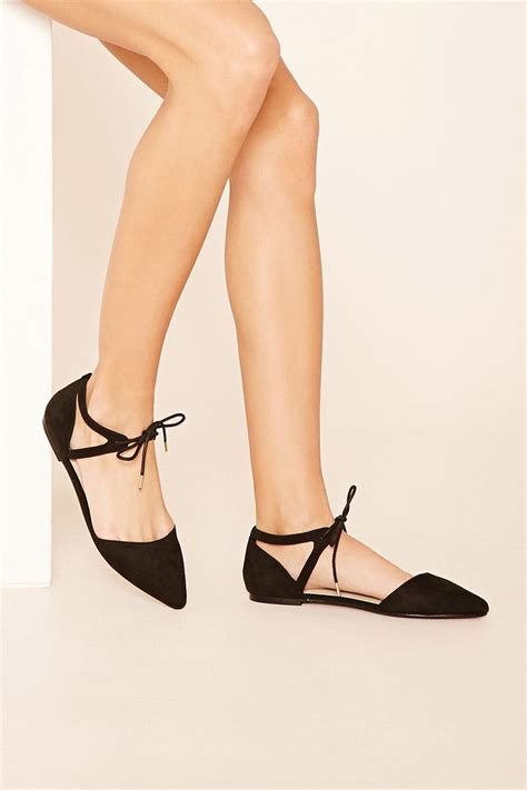 A Pair Of Faux Suede D Orsay Flats Featuring A Lace Up Ankle Strap And A Pointed Closed Toe