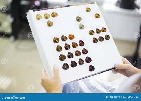 Close Up Of A Female Client Examining Hair Color Chart At The