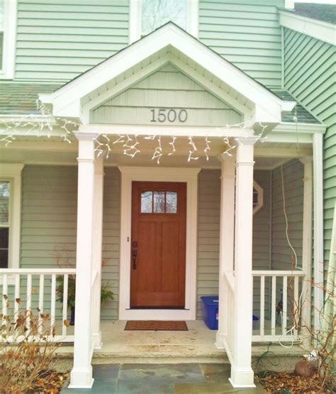 Coastal Sage Vinyl Siding With White Trim And Fiberglass Front Door