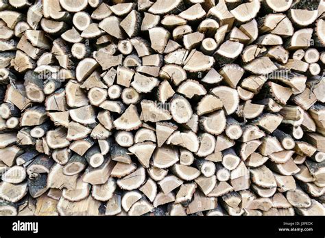 Background Of Dry Chopped Oak Firewood Logs Stacked Up On Top Of Each